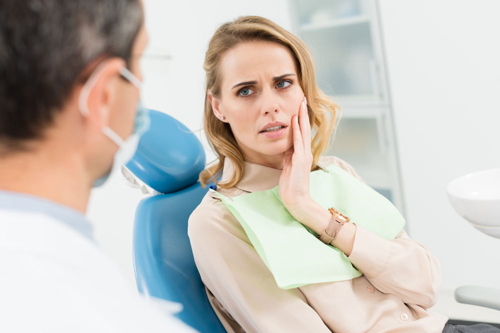 Female,Patient,Concerned,About,Toothache,In,Modern,Dental,Clinic