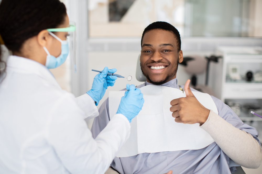 Happy,Black,Male,Patient,Showing,Thumb,Up,While,Having,Check