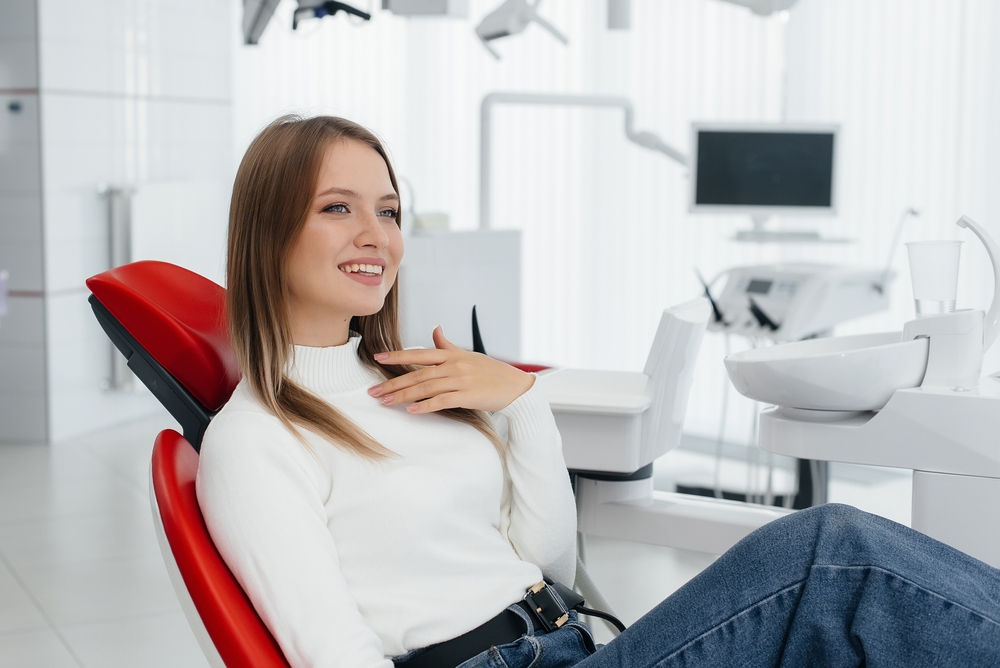 A,Beautiful,Young,Woman,Is,Sitting,On,A,Red,Dental