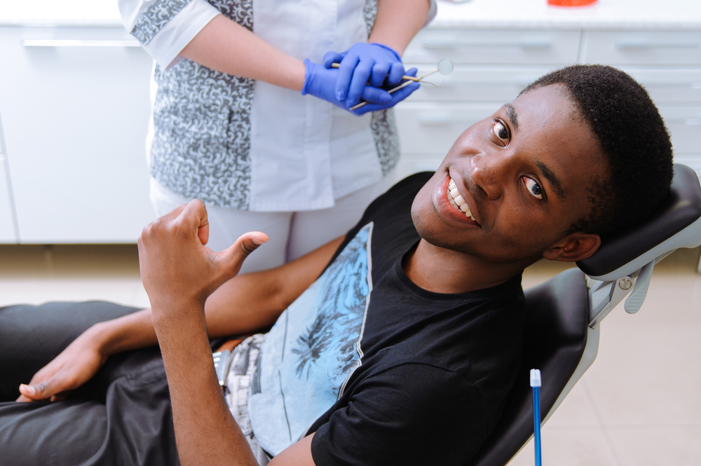 African,Patient,In,Dentistry,Smiling,In,Dental,Chair
